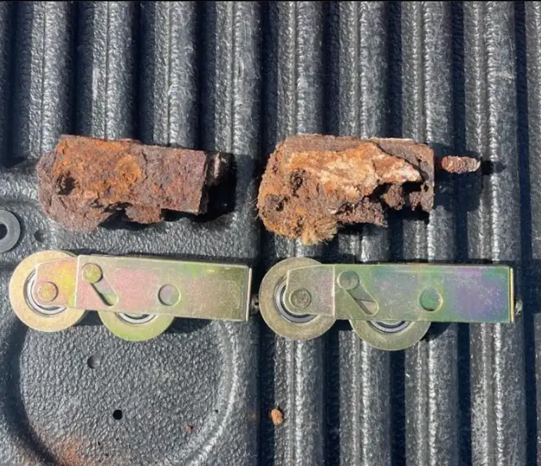 Water leaking under sliding glass door tracks corroded these rollers, shown beside new replacements